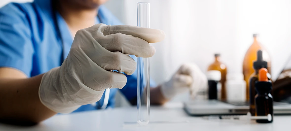 cannabis testing, hand in medical gloves holding a test tube